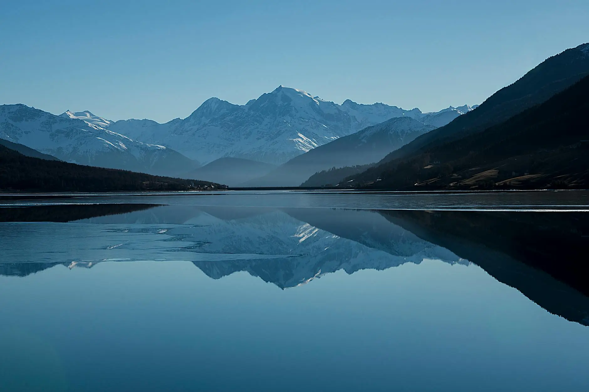 A photograph of a lake with mountains, with a text watermark applied.